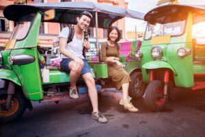 couple sitting on tuk tuk in thailand